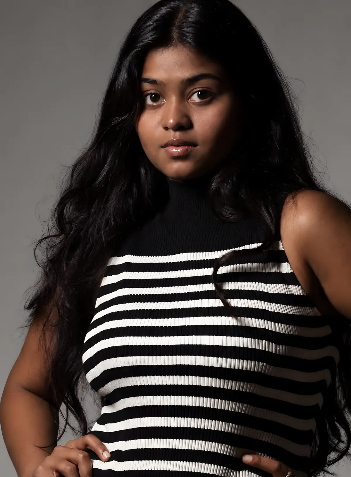 Portrait of Madhumitha Mummadisetty in a black and white striped top